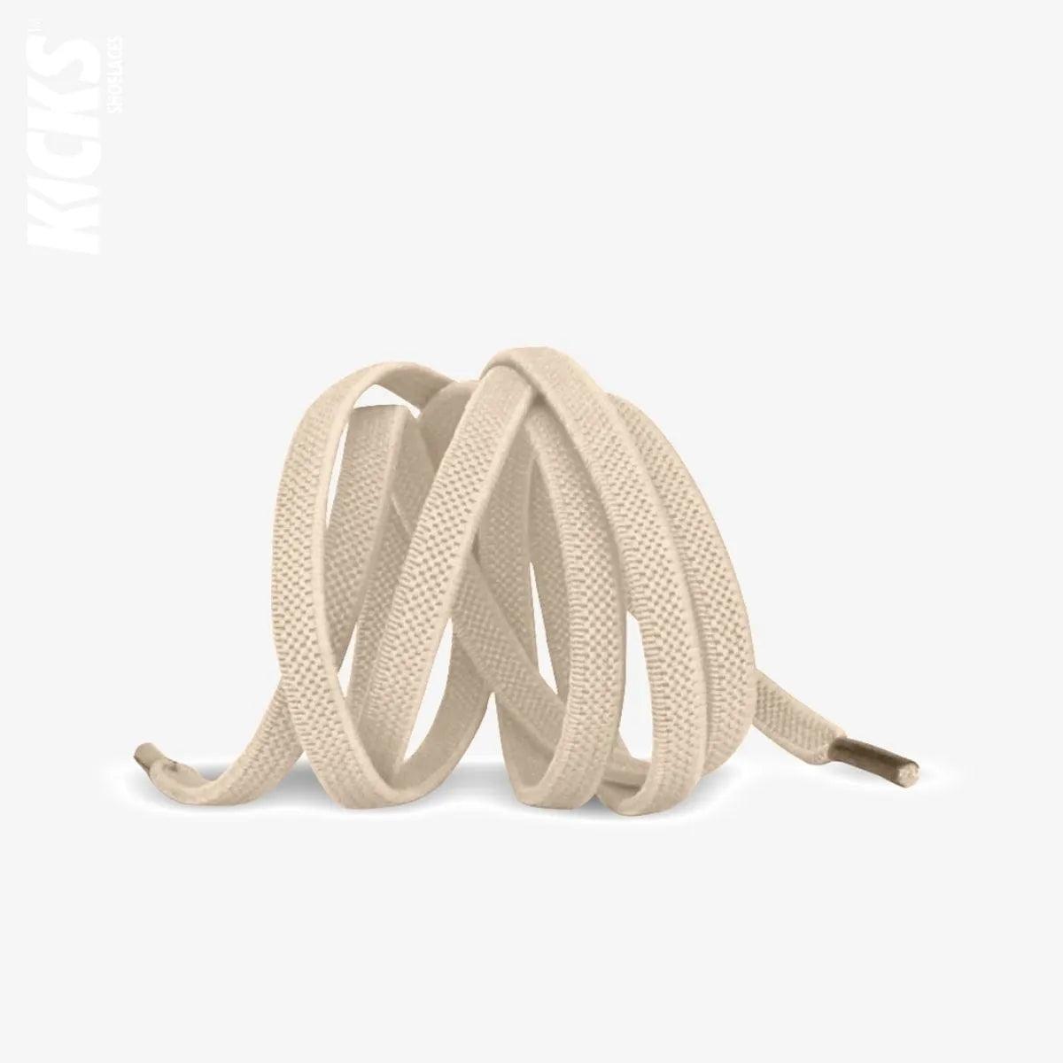 Beige elastic no-tie shoelaces with a buckle lock system installed on sneakers for a secure slip-on fit without tying the laces, by Kicks Shoelaces.