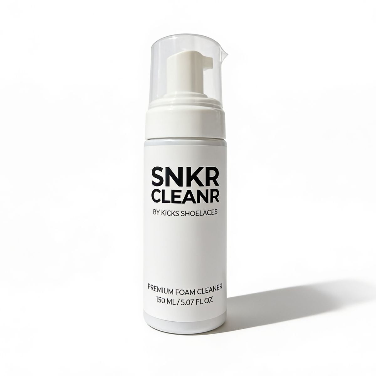 A white bottle of SNKR Cleaner Premium Foam Cleaner by Kicks Shoelaces, featuring a clear cap and white pump dispenser, set against a clean white background with a soft shadow.