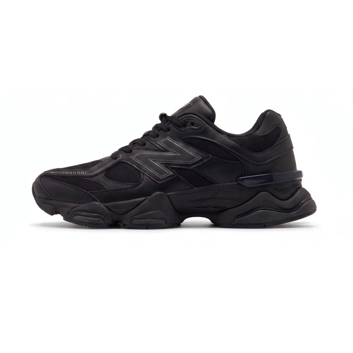 A black New Balance chunky sneaker shown from the side profile against a clean white background.