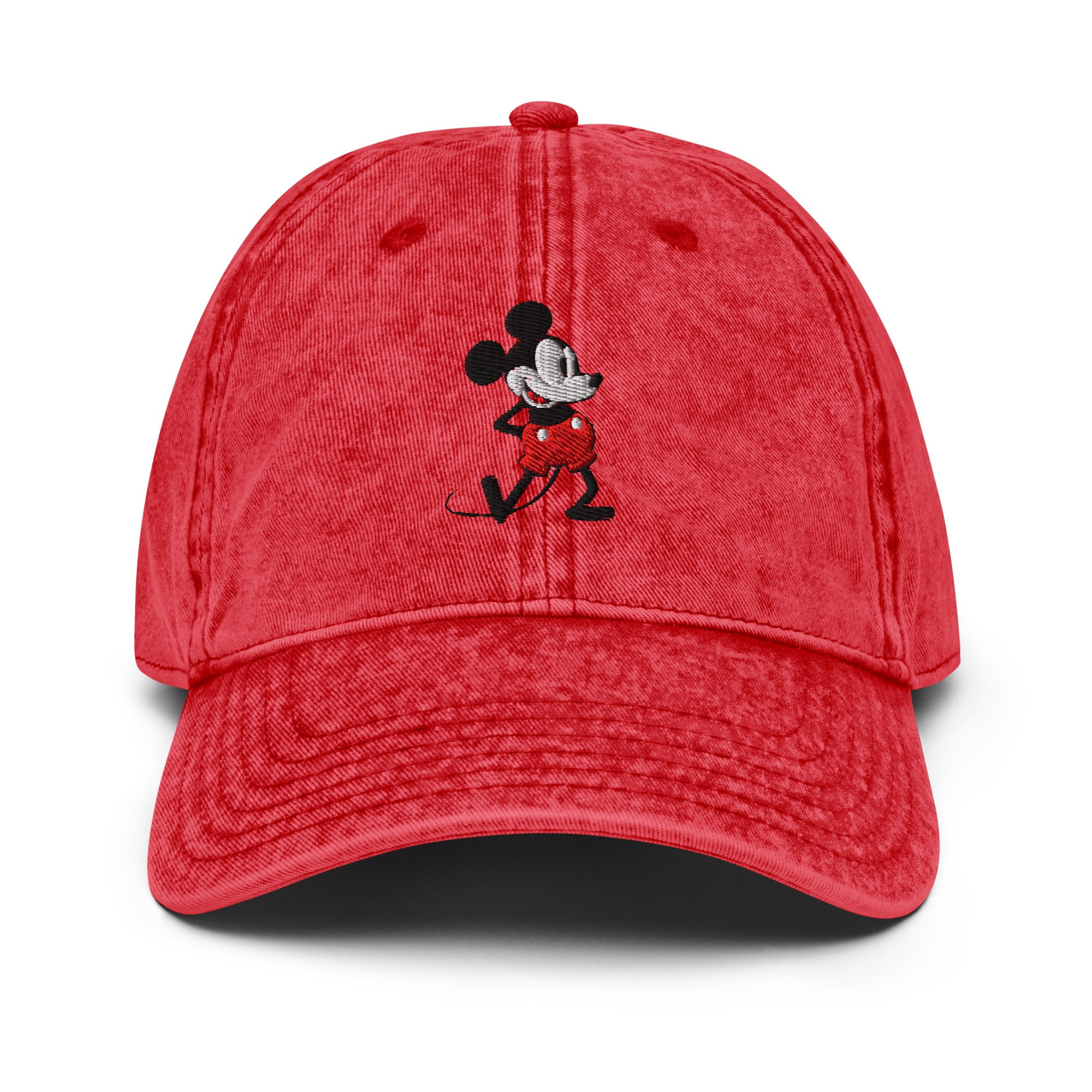 Red baseball cap with a 1928 Mickey Mouse steamboat willie cartoon character embroidered on it.